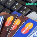 "Three credit cards laid out in a row with a magnifying glass over one, illustrating different methods of carding such as dumps, CVV, and BIN attacks."